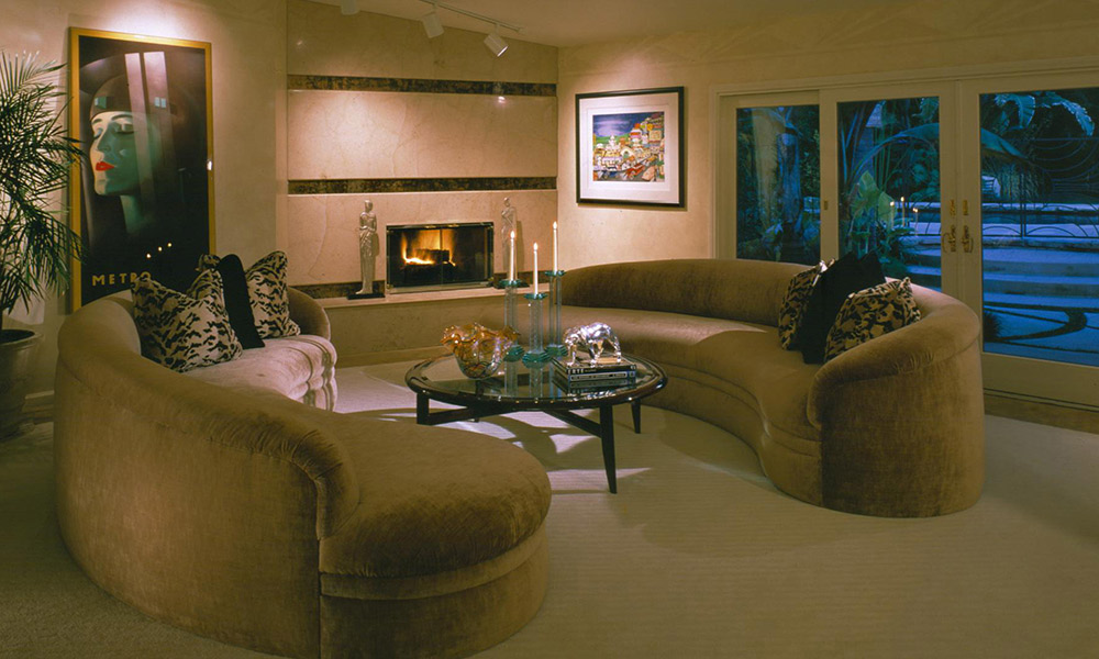 c shaped sofa,  velvet curved sofa, art deco living room, hollywood flair, contemporary fireplace, sophisticated living room